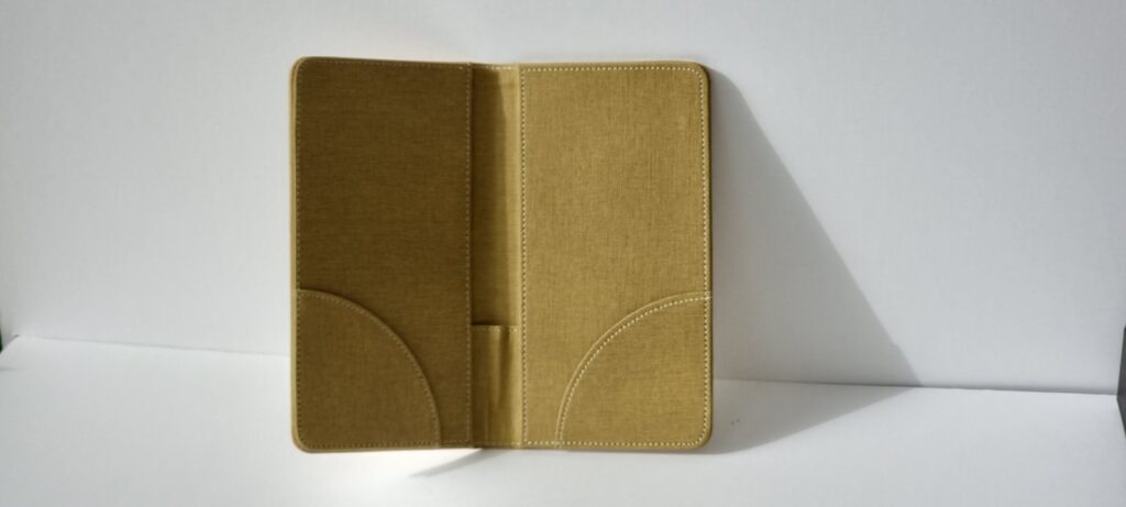 An open tan folder standing on a white background.
