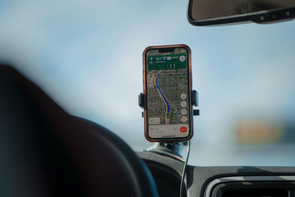 Smartphone navigation app displaying a route on car dashboard