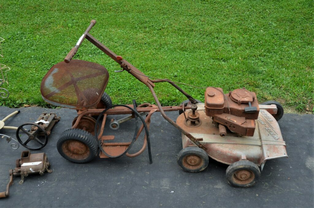 a lawn mower sitting on top of a cement slab