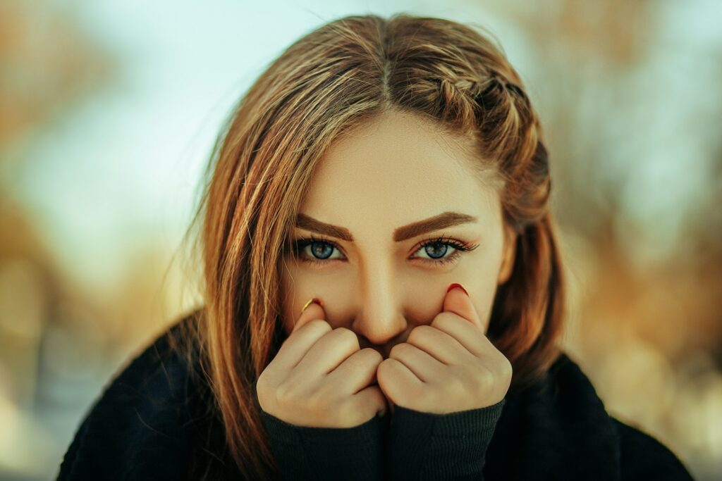 a woman covering her face with her hands