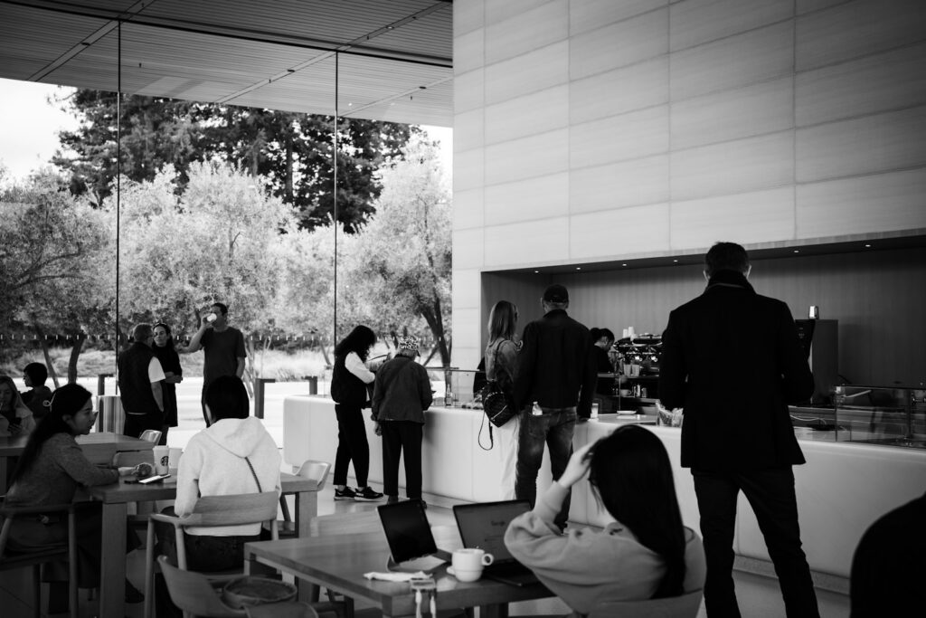 People gathered in a modern cafe with large windows