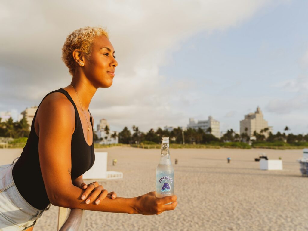 woman in black tank top holding bottled water