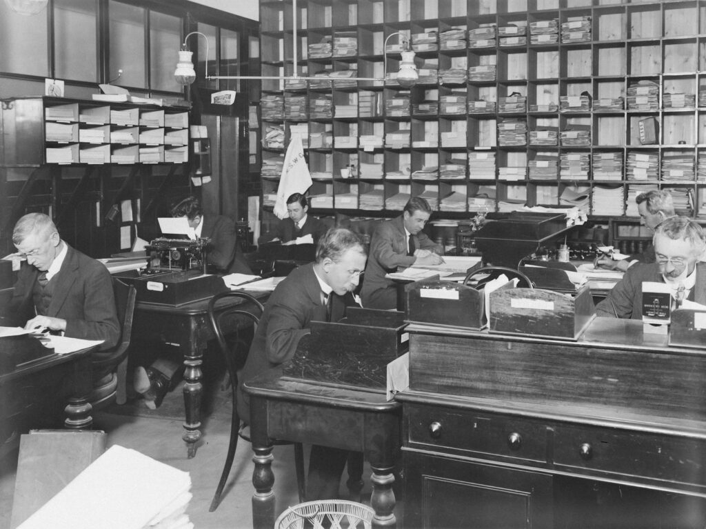 a black and white photo of people in a library