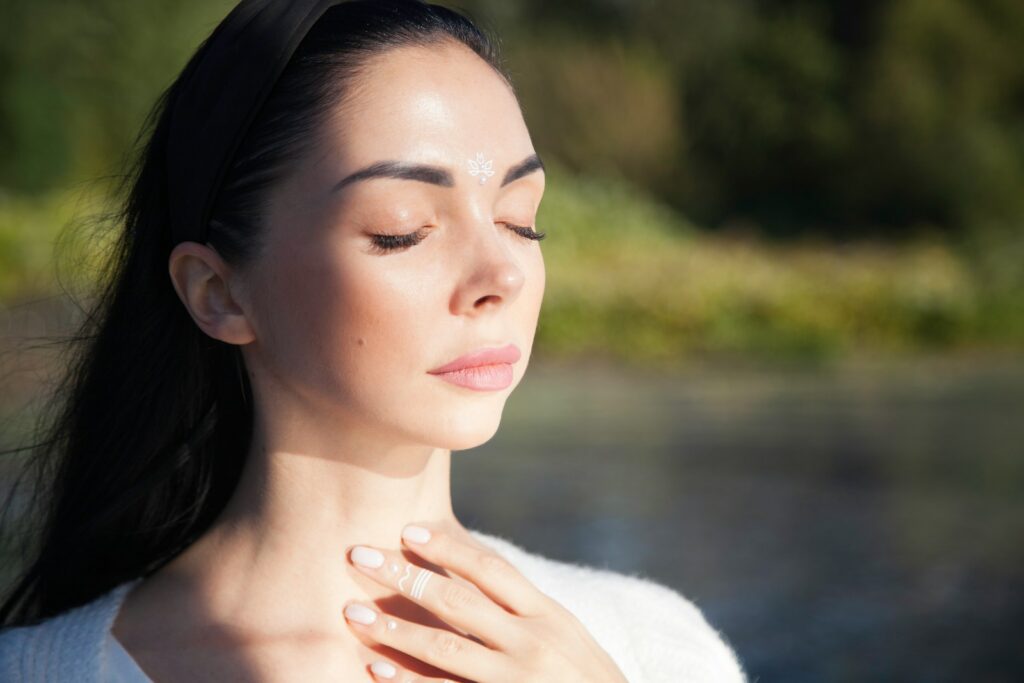 a woman with her hands on her chest