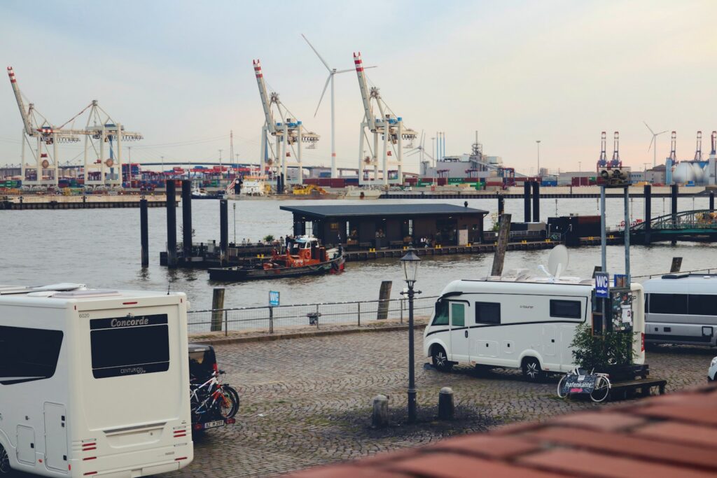 a group of vehicles parked next to a body of water