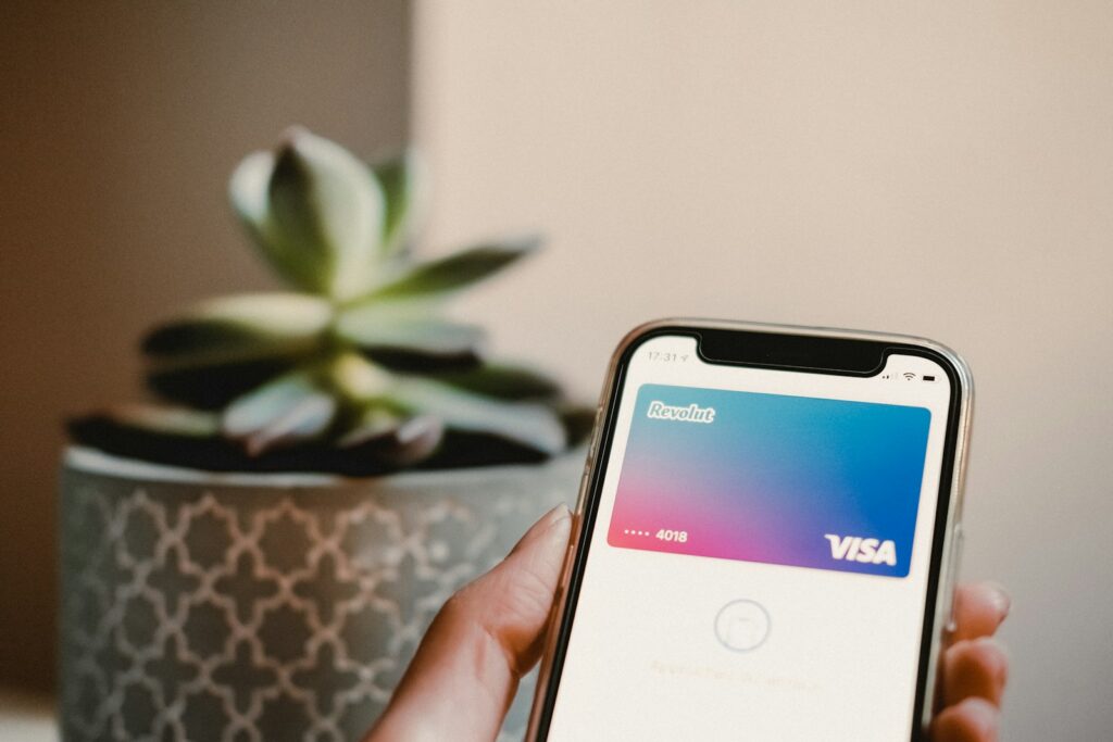 person holding black samsung with banking app