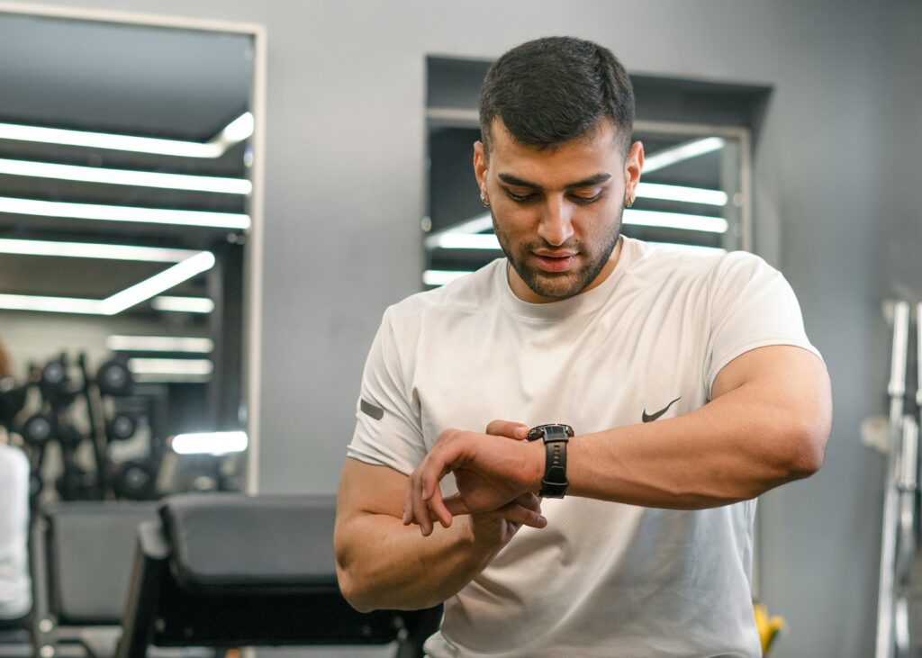 Man checking smartwatch in a gym.