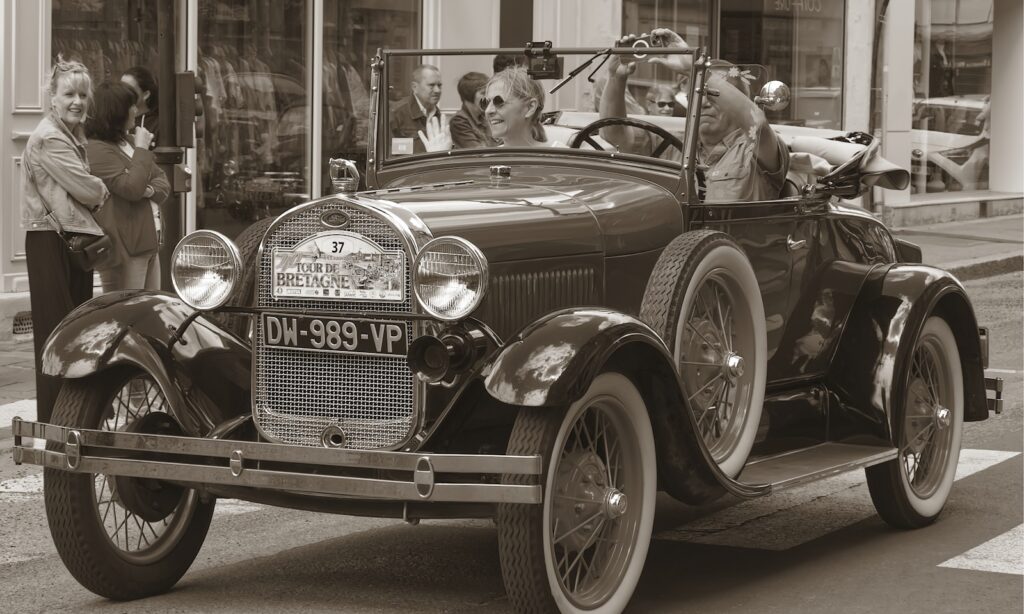 Vintage car with people observing.