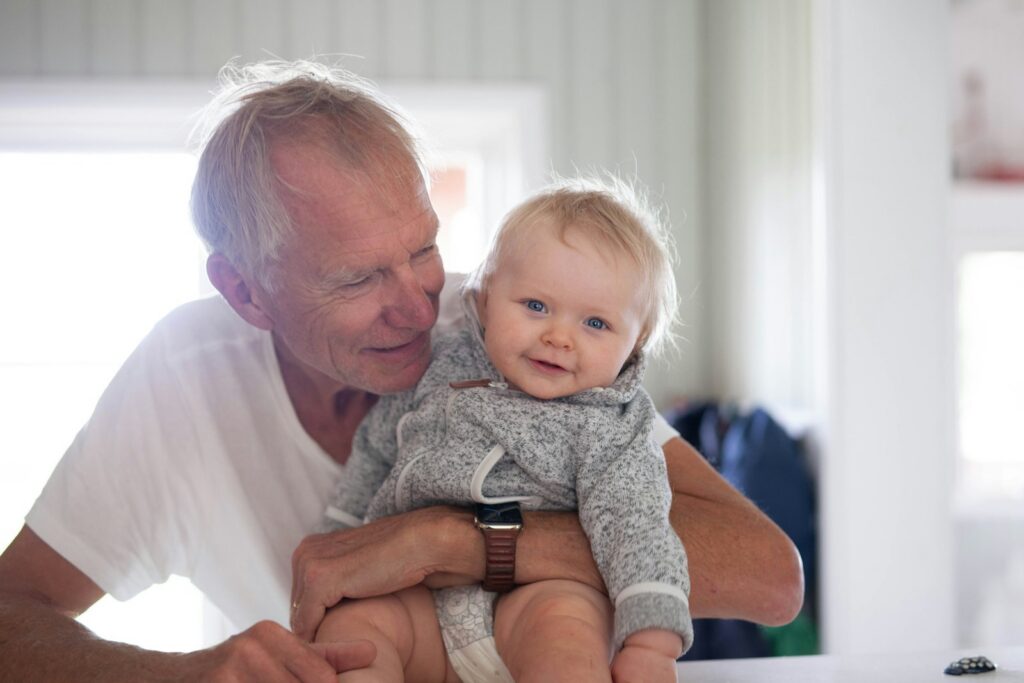 Grandfather holding a baby in his arms