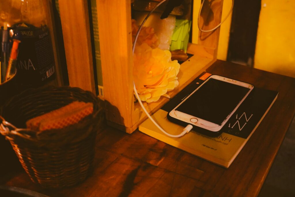 a cell phone sitting on top of a wooden table