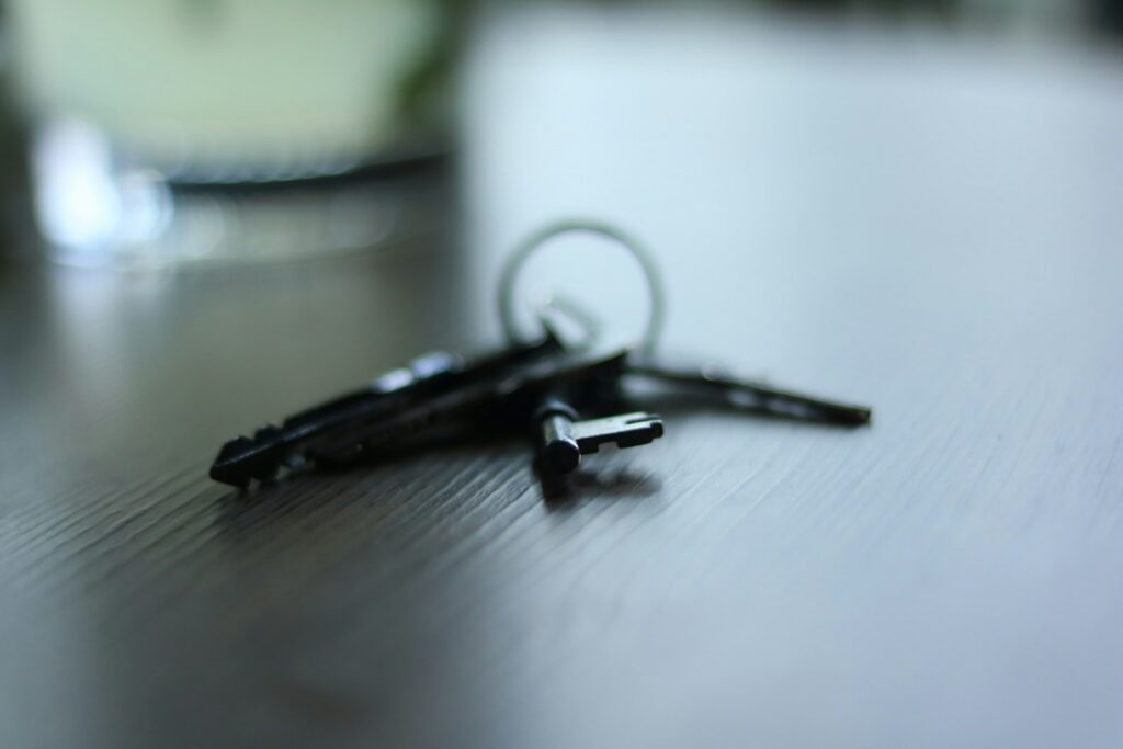a pair of scissors sitting on top of a wooden table