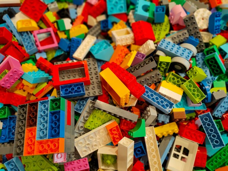 a pile of multicolored legos sitting on top of a table