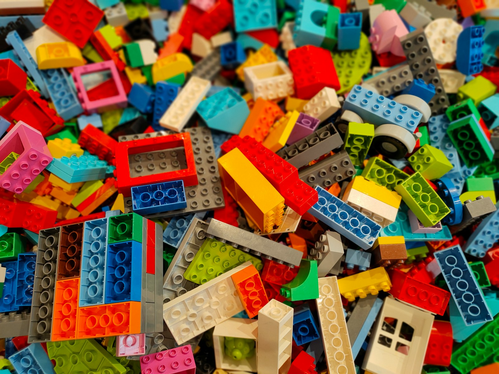 a pile of multicolored legos sitting on top of a table