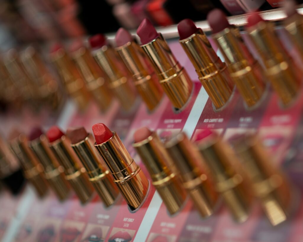 many lipsticks are lined up on a shelf