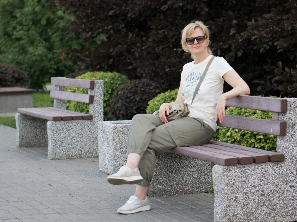 A woman sitting on a bench in a park