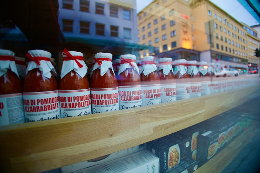a row of bottles of hot sauce on a shelf