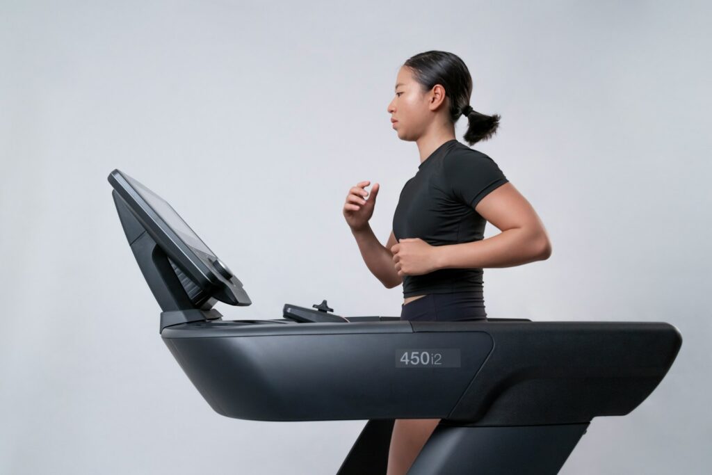 a woman is running on a treadmill to improve heart health