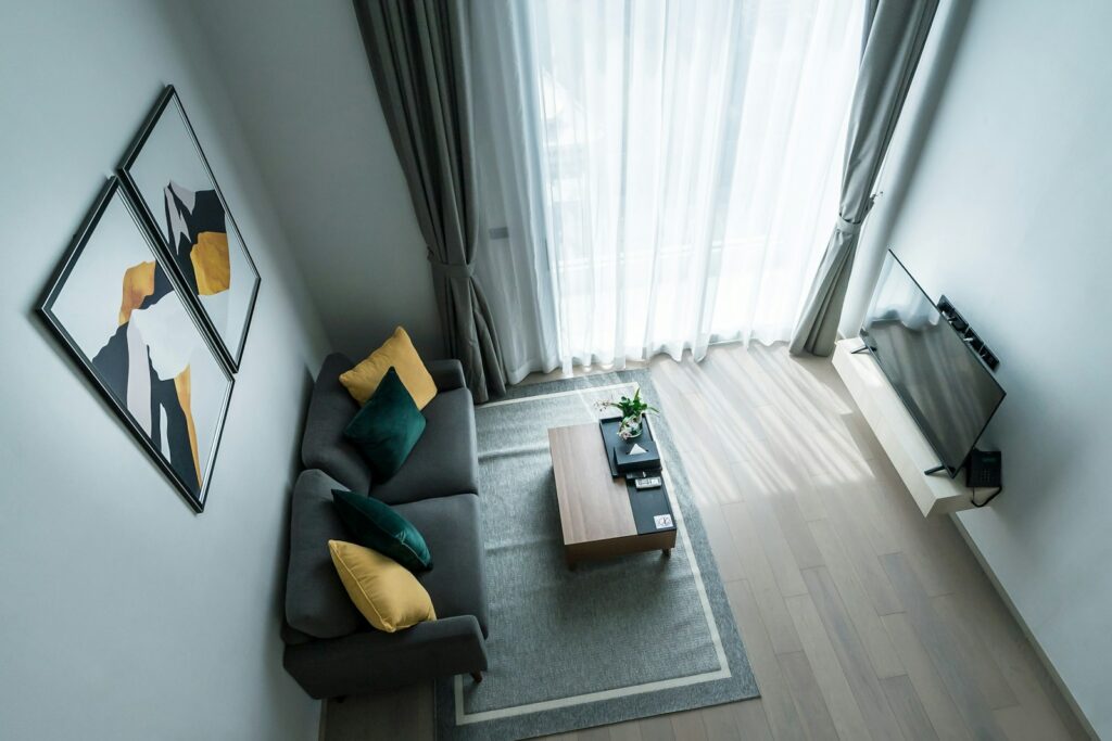 Modern living room with gray sofa and abstract art.