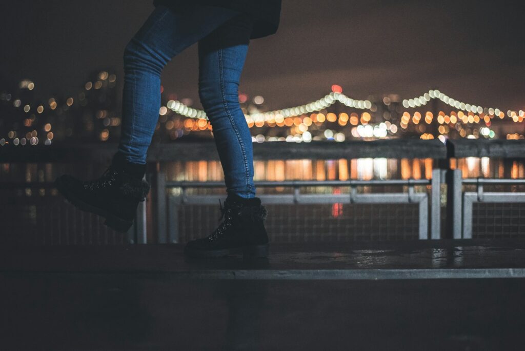 person wearing blue denim jeans and pair of black boots
