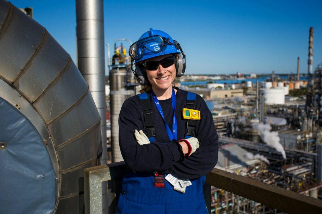 Woman engineer smiles, working in a plant.