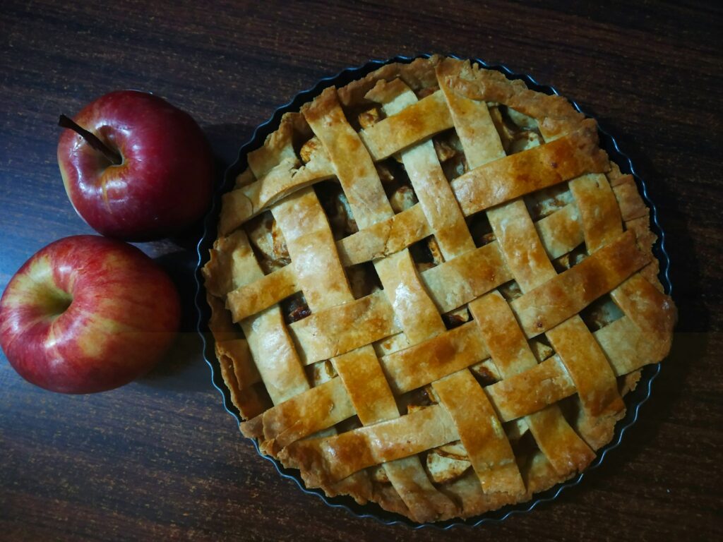 red apple beside brown pie