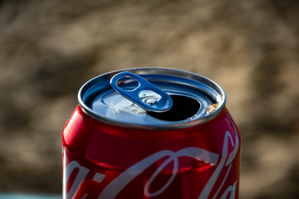 Can of Coca Cola soda with open can tab