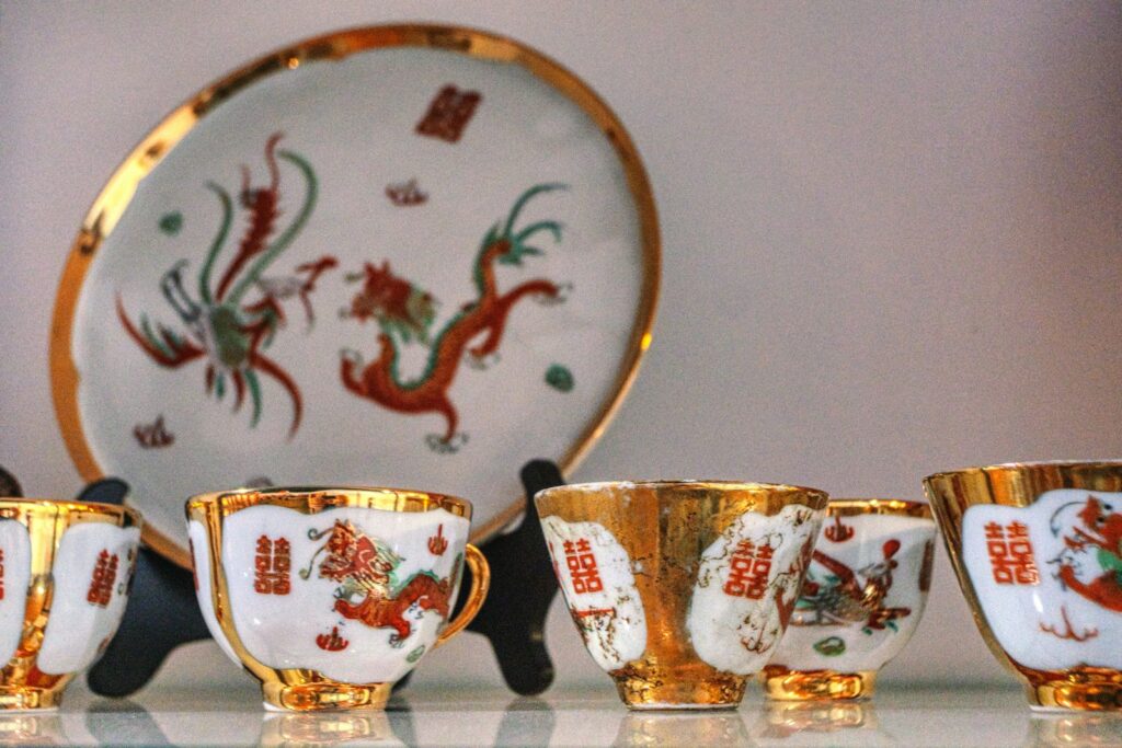A group of gold and white cups and saucers