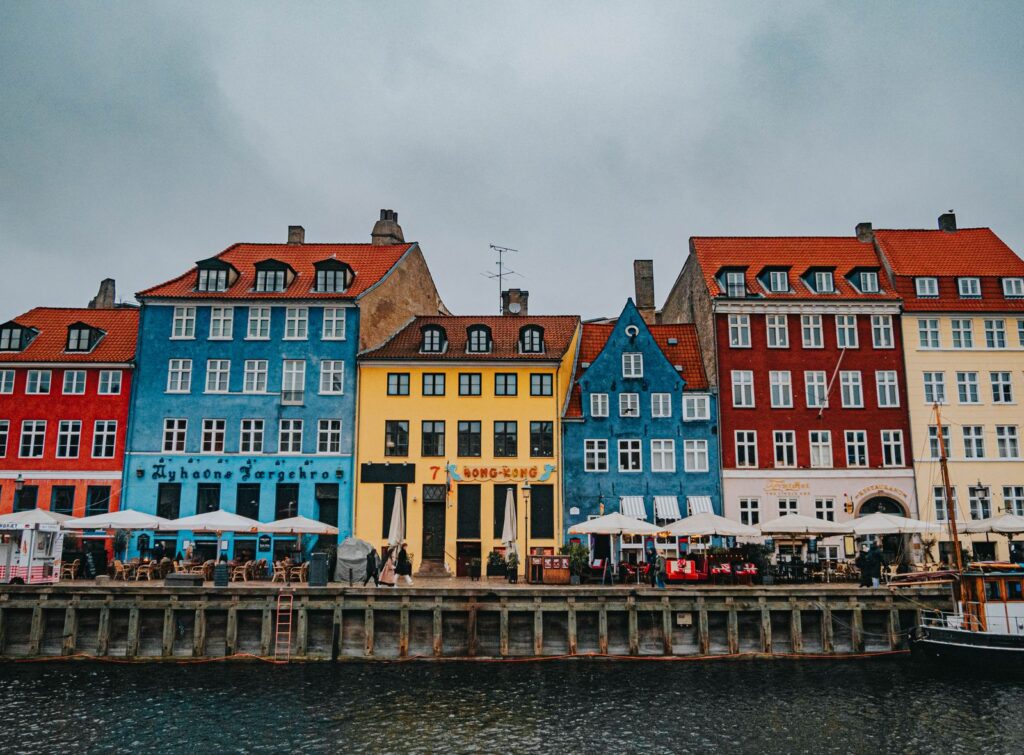 Vibrant Nyhavn harbor in Copenhagen showcasing colorful historic buildings by the water.