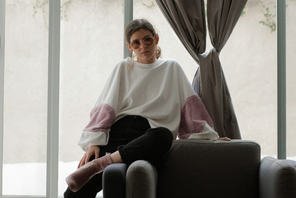 woman sitting on brown armchair