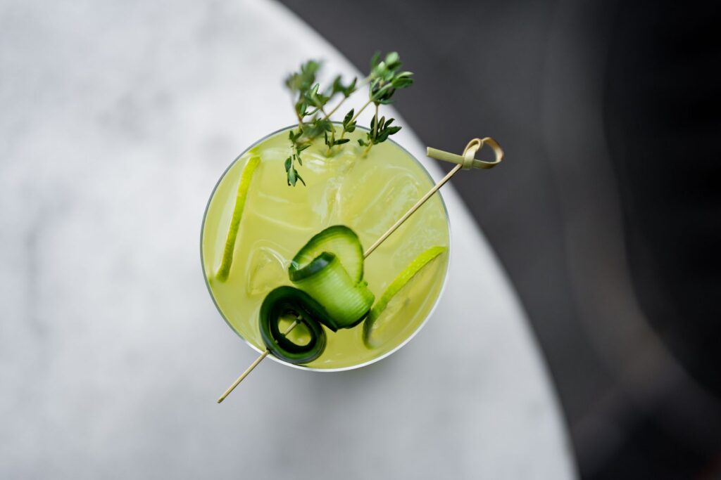 Elegant cocktail with cucumber garnish from above, captured in a stylish bar setting in Istanbul.