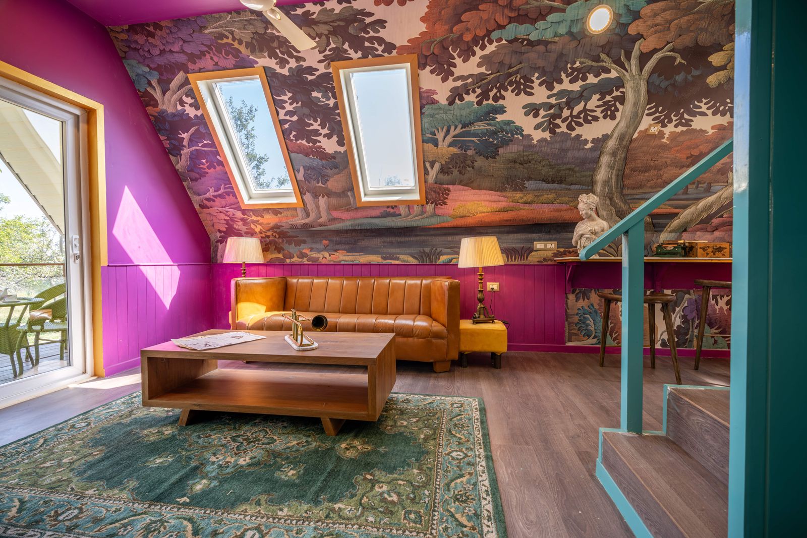 Vibrant living room featuring colorful wallpaper, skylights, and modern decor.