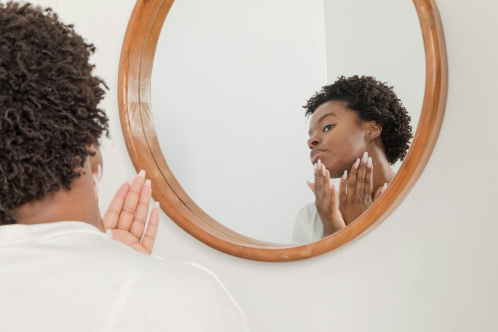 Woman checking face in the mirror