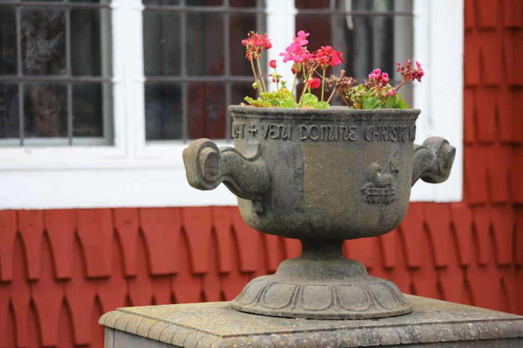A potted planter sitting on top of a cement pedestal