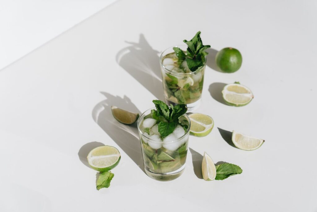 A refreshing mojito cocktail with lime and mint, perfect for a cool, summer refreshment.