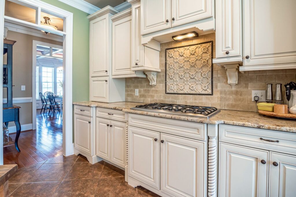 Bright and elegant kitchen interior showcasing marble countertops and classic cabinetry design.
