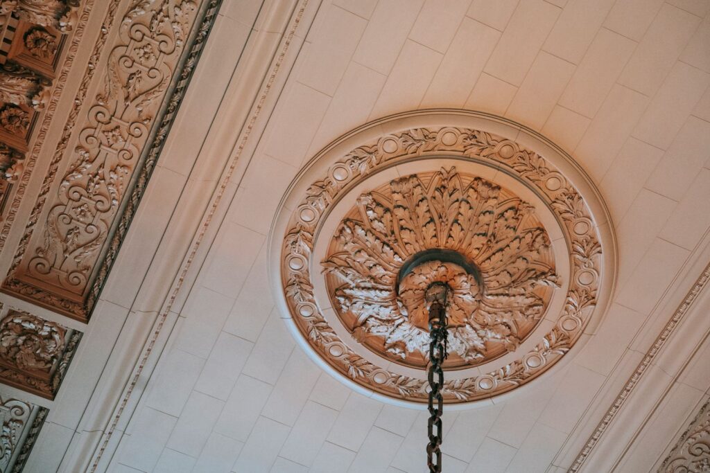 From below of public structure with classic interior and ornamental elements on ceiling