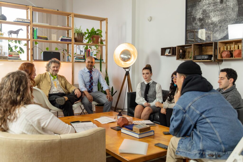 A diverse team gathered for a meeting in a modern office with creative decor, discussing plans.