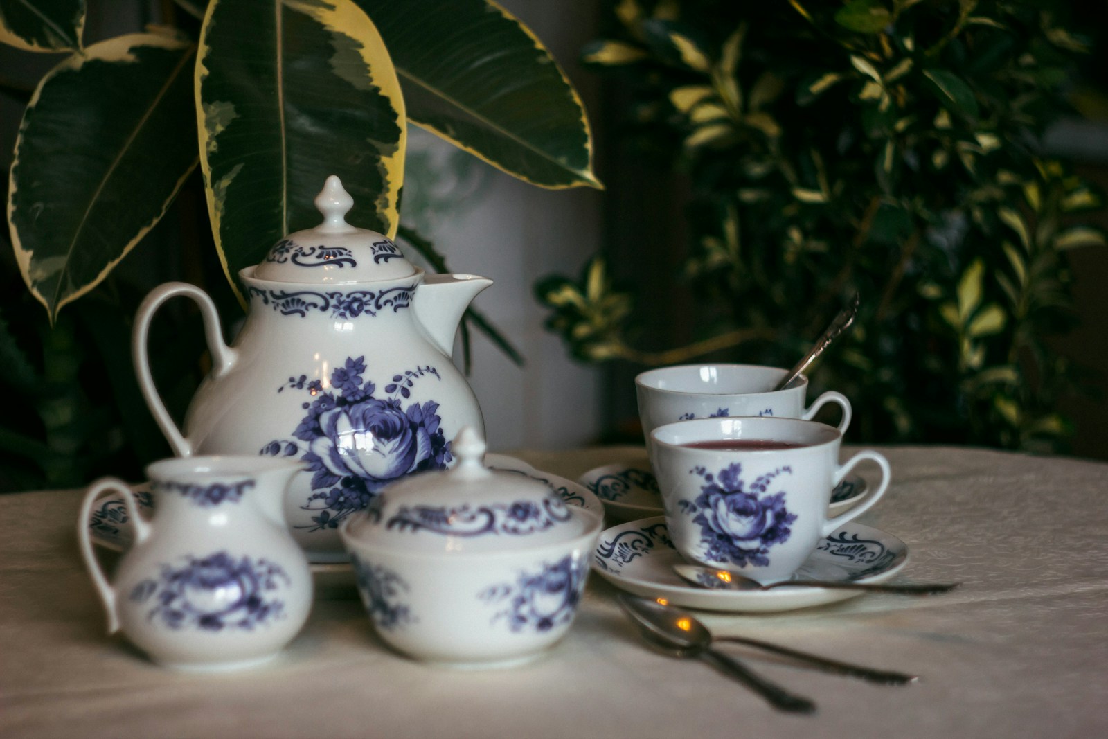 white and blue floral ceramic teacup set