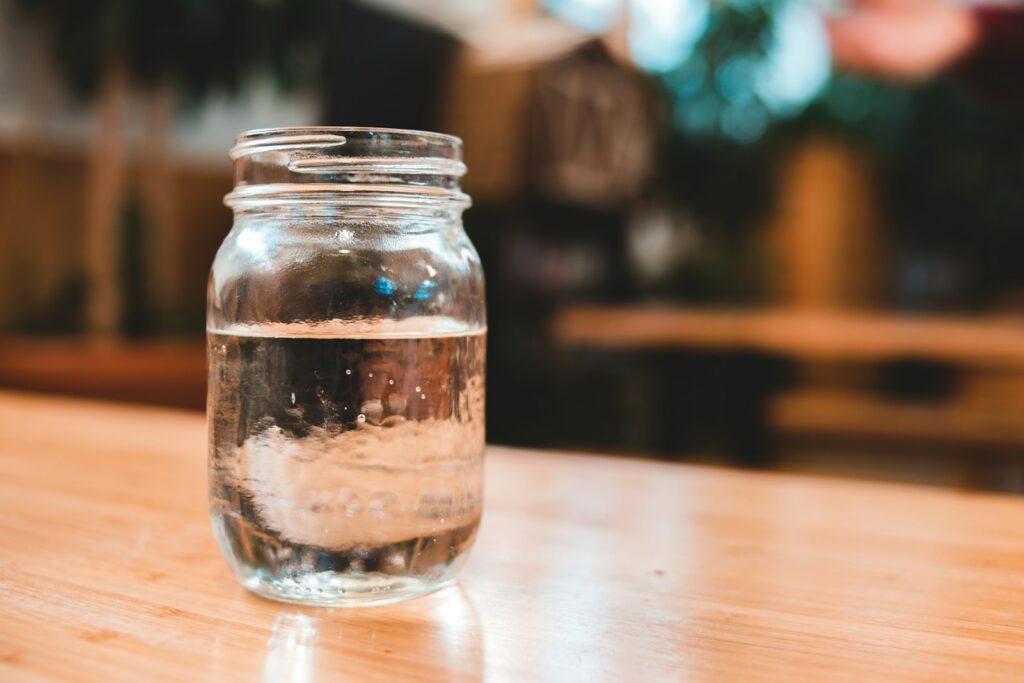 clear glass jar on brown wooden table
