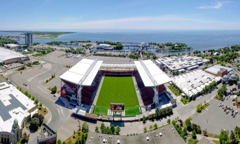 Stunning aerial view of BMO Field and Toronto's scenic waterfront on a clear summer day.