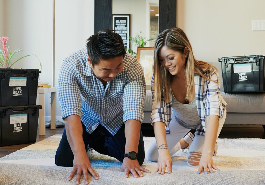 man and woman sitting on floor