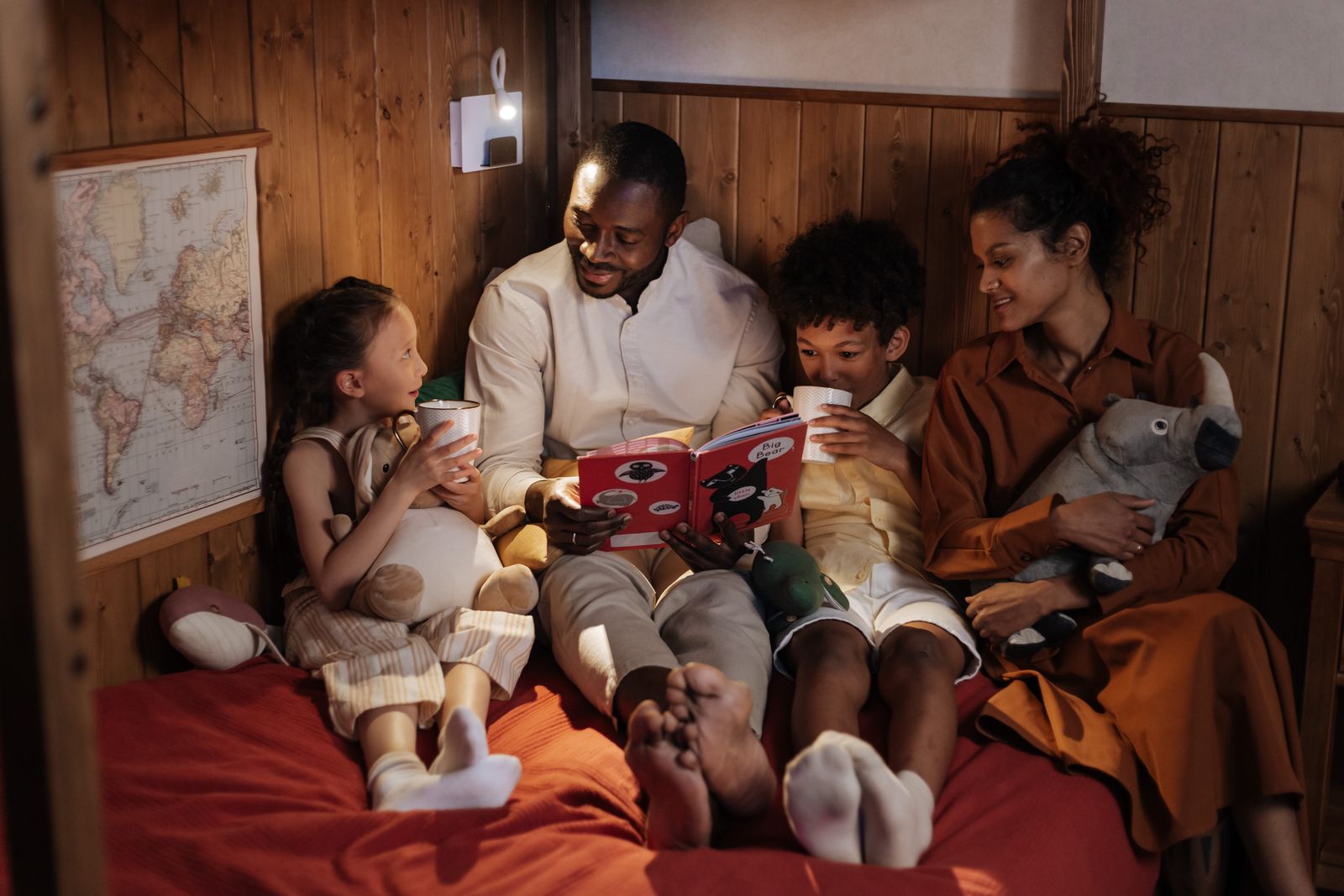 Parents reading bedtime story to kids