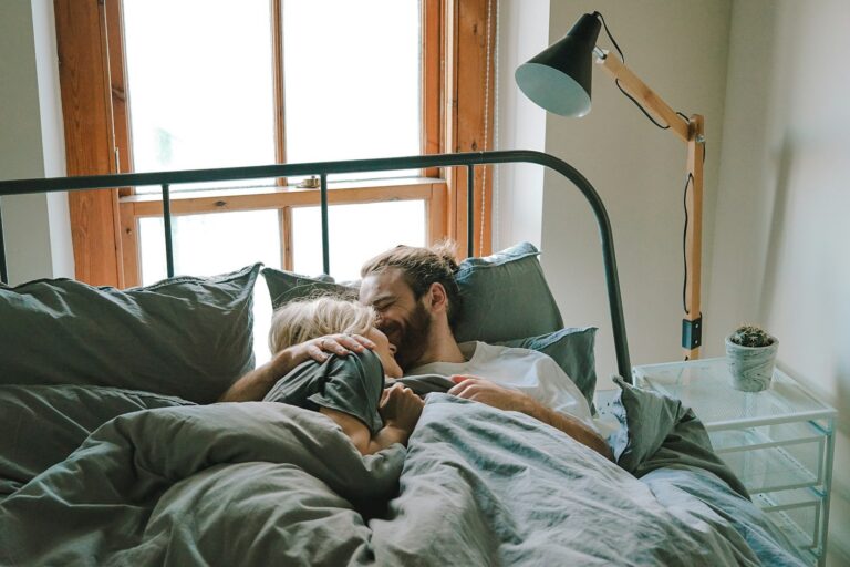 Sweet couple comfortably relaxing in bed