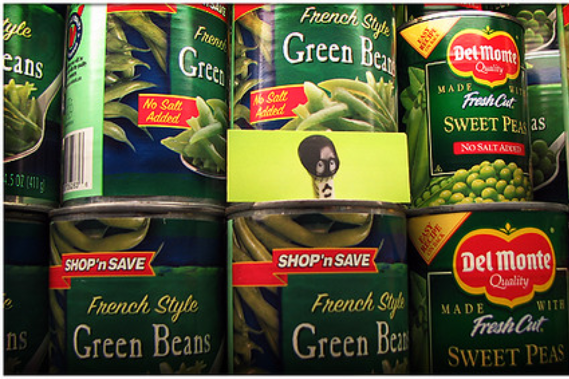 Stack of canned green beans at the grocery store