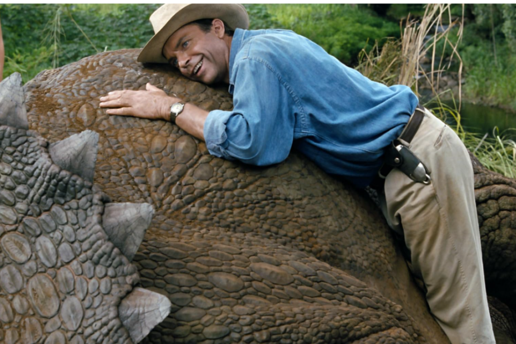 Dr. Alan Grant closely observes a Triceratops in Jurassic Park.