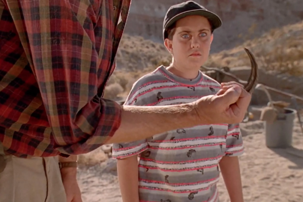 Dr. Alan Grant uses a raptor claw to explain dinosaur behavior.