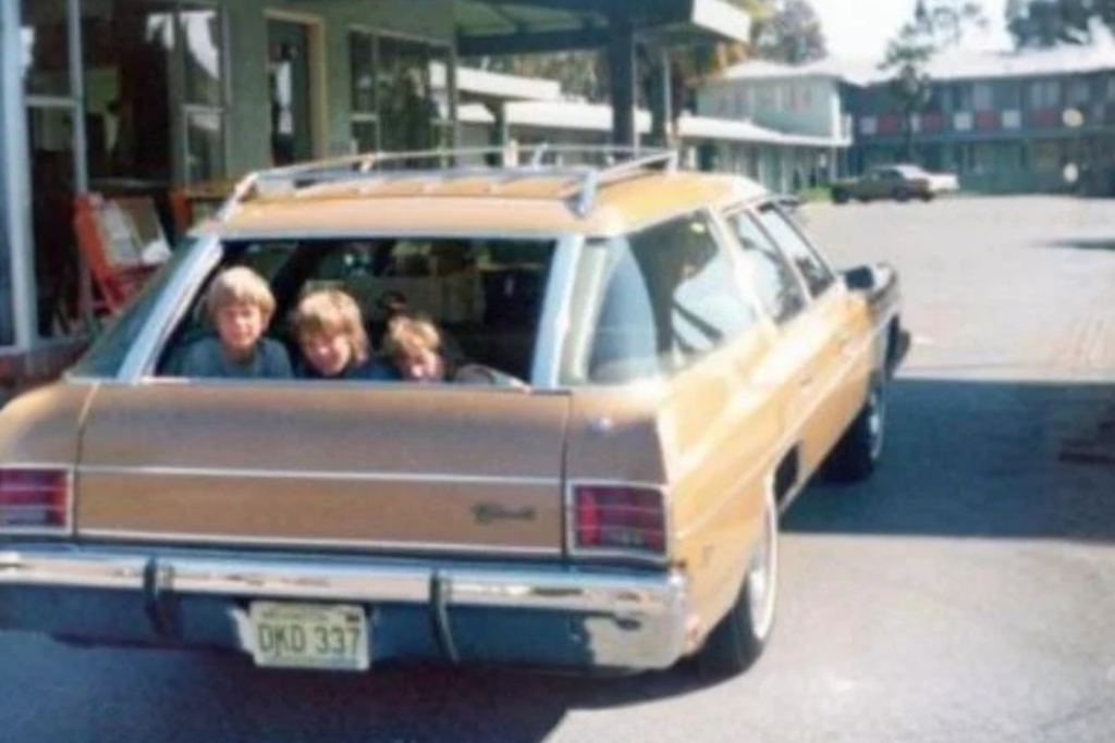 Kids riding in vintage car without seatbelt