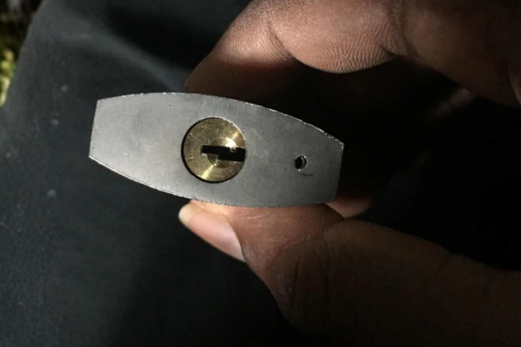 Close-up of a padlock drain hole