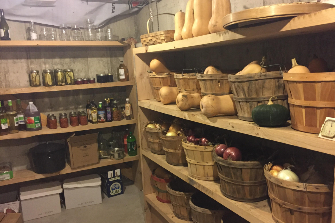Root cellar filled with preserved food and baskets of vegetables