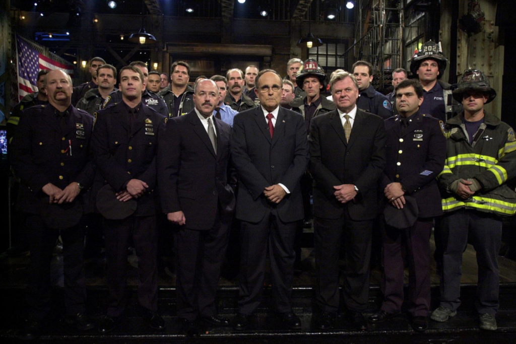 Rudy Giuliani stands with New York police officers and firefighters after the 9/11 attacks.
